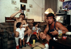 Peter drinks a beer with a friend as his children watch TV.jpg