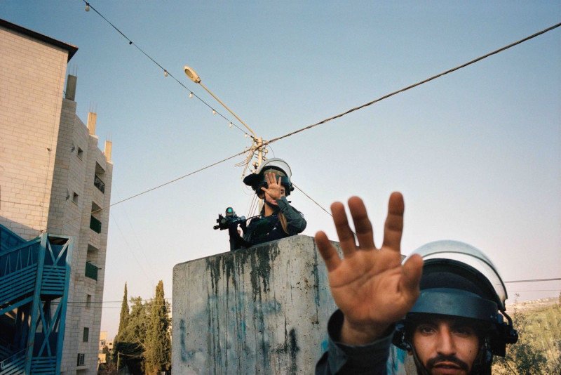 Israeli soldiers motion toward the camera to cease taking photos 2022 C Adam Rouhana