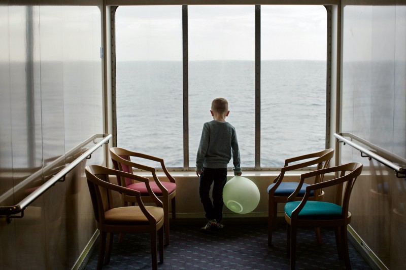 8_A young boy looks out of a window while travelling on the ferry 